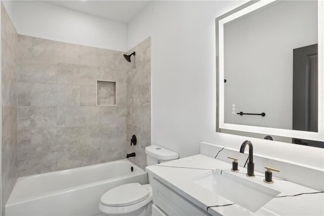 full bathroom with tiled shower / bath combo, toilet, and vanity