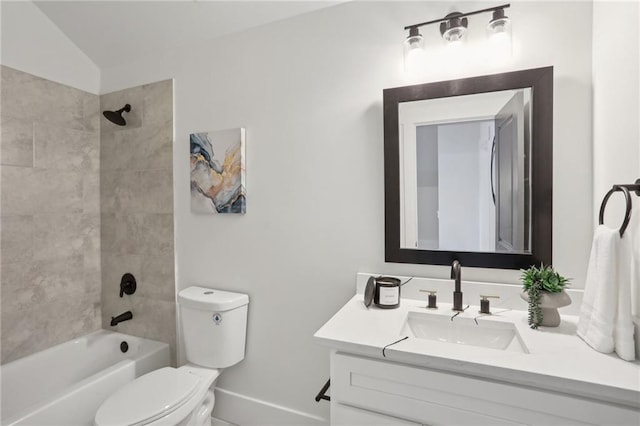 full bathroom with vanity, toilet, tiled shower / bath, and lofted ceiling