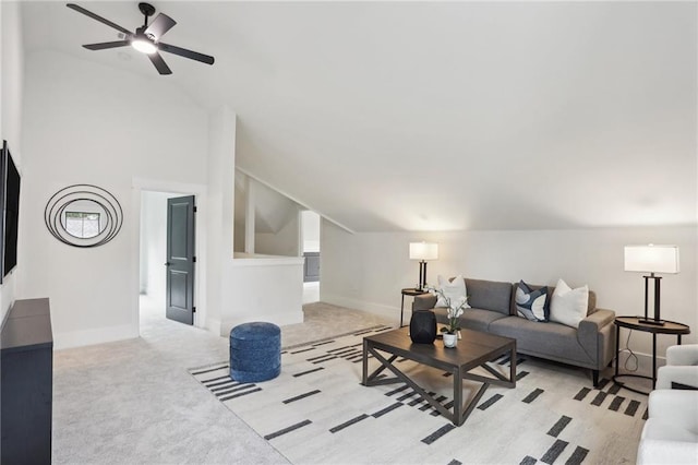 living room featuring ceiling fan, light colored carpet, and lofted ceiling