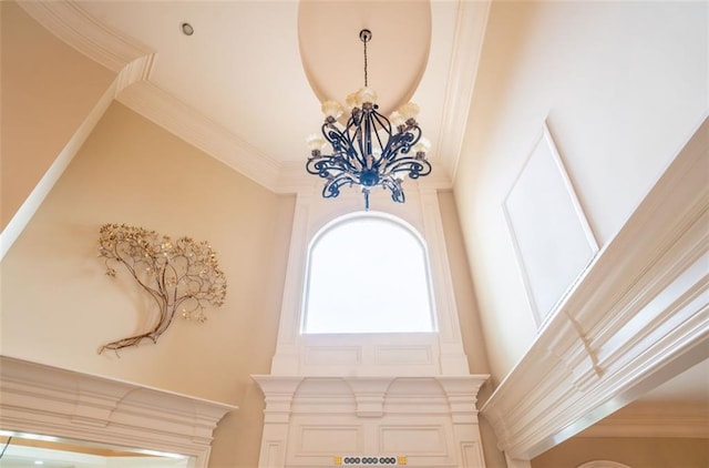 room details with ornamental molding and a chandelier