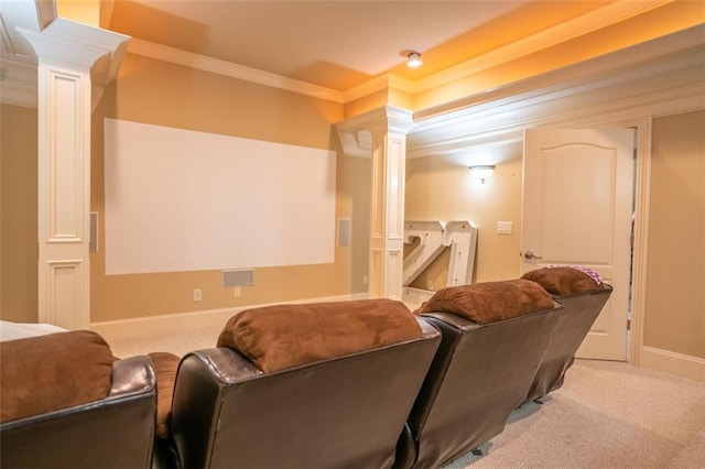 home theater featuring decorative columns, light carpet, and ornamental molding