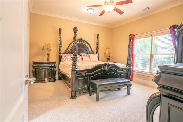 carpeted bedroom featuring ceiling fan and ornamental molding