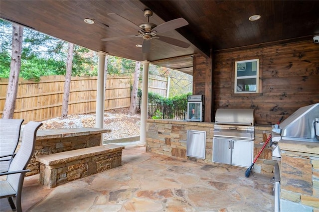 view of patio with area for grilling, ceiling fan, and an outdoor kitchen