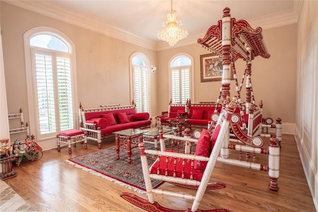 interior space with an inviting chandelier, ornamental molding, and hardwood / wood-style flooring