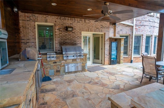 view of patio with an outdoor kitchen, area for grilling, and ceiling fan