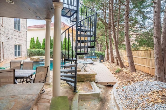 view of patio / terrace featuring a pool with hot tub