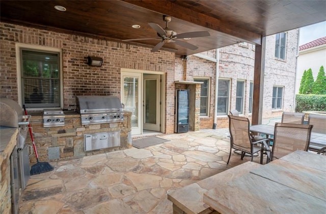 view of patio / terrace with an outdoor kitchen, area for grilling, and ceiling fan