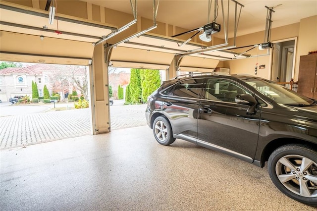 garage with a garage door opener and a carport