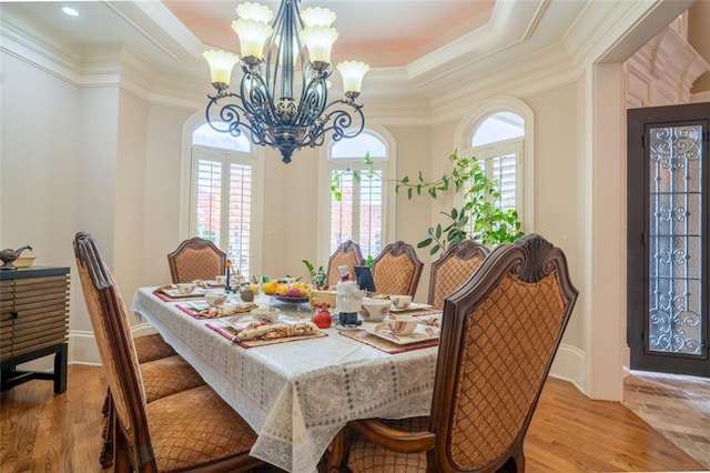 dining space featuring light hardwood / wood-style floors, a wealth of natural light, and crown molding