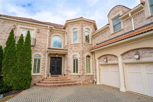 view of front of property featuring a garage and french doors