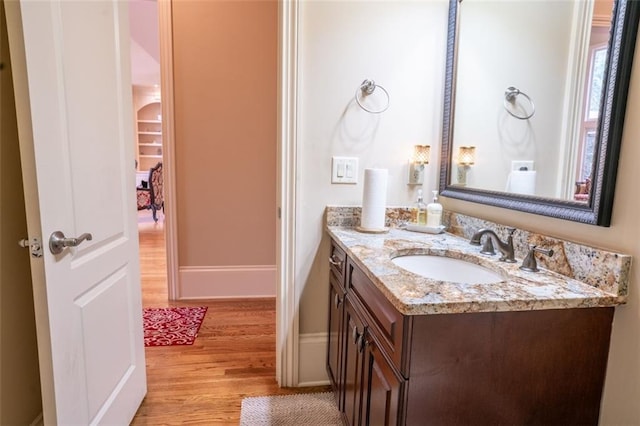 bathroom with hardwood / wood-style floors and vanity