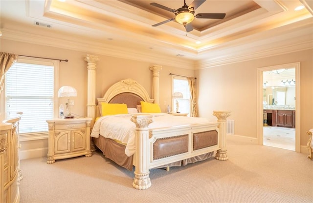 bedroom featuring light carpet, a tray ceiling, and ceiling fan