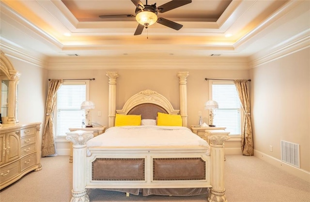 carpeted bedroom with a raised ceiling, ceiling fan, and ornamental molding