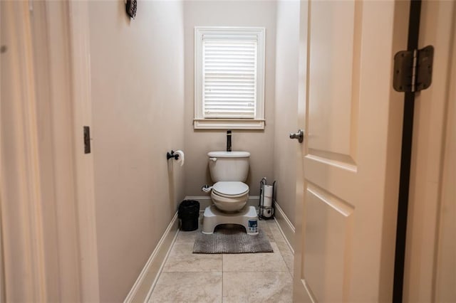 bathroom with tile patterned flooring and toilet