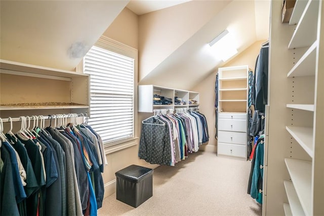 spacious closet featuring lofted ceiling and light carpet