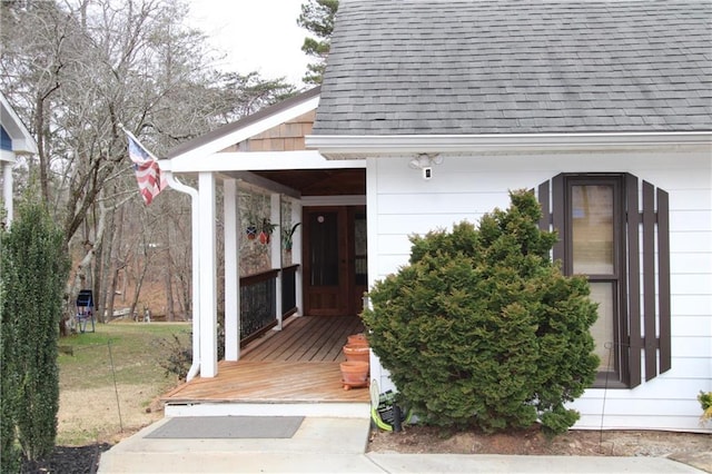 doorway to property with a shingled roof