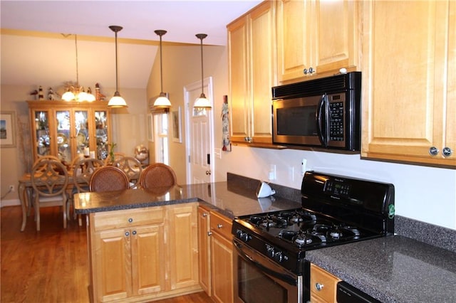 kitchen with a peninsula, black appliances, light wood finished floors, and lofted ceiling