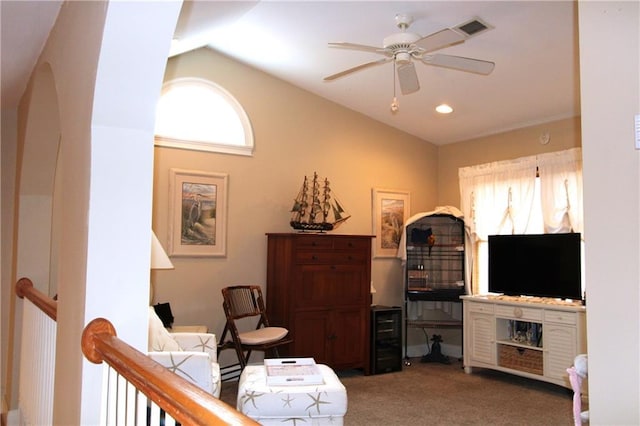 living area featuring light carpet, beverage cooler, visible vents, ceiling fan, and vaulted ceiling