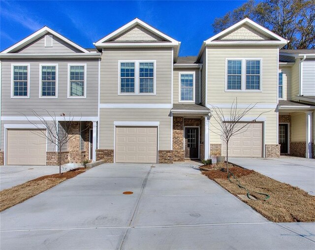 townhome / multi-family property featuring a garage