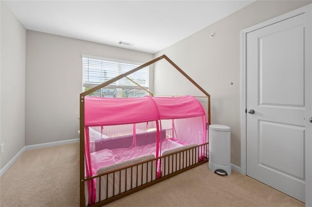 carpeted bedroom with baseboards and visible vents