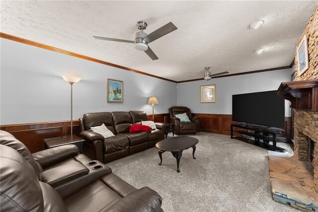 1172 Malvern Hunt Ct, Lawrenceville, GA 30043 - carpeted living area featuring wainscoting, ceiling fan, a stone fireplace, a textured ceiling, and wooden walls