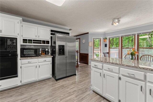 1172 Malvern Hunt Ct, Lawrenceville, GA 30043 - kitchen with black appliances, crown molding, white cabinets, a textured ceiling, and light wood-style flooring