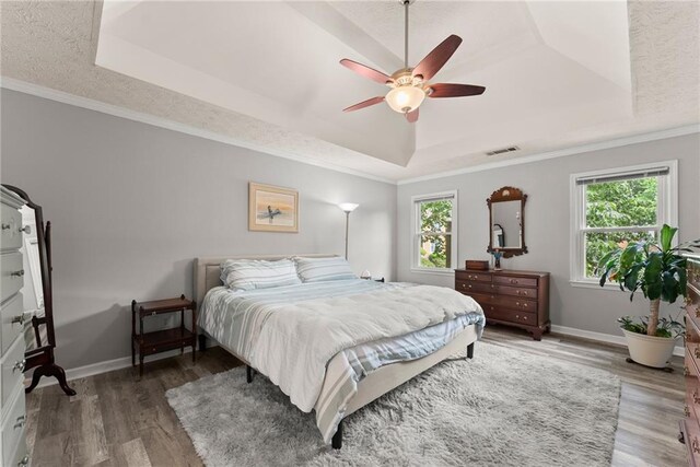 1172 Malvern Hunt Ct, Lawrenceville, GA 30043 - bedroom with a tray ceiling, wood finished floors, baseboards, a ceiling fan, and crown molding