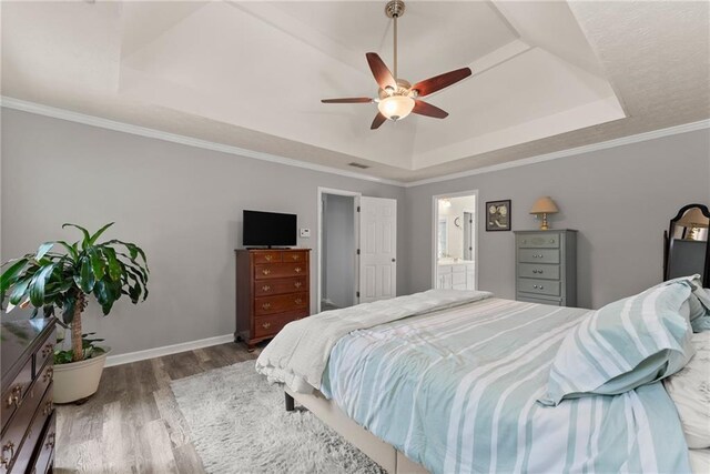 1172 Malvern Hunt Ct, Lawrenceville, GA 30043 - bedroom with a raised ceiling, wood finished floors, baseboards, ceiling fan, and connected bathroom