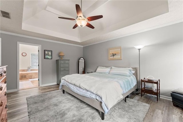 1172 Malvern Hunt Ct, Lawrenceville, GA 30043 - bedroom with a tray ceiling, wood finished floors, baseboards, and ornamental molding