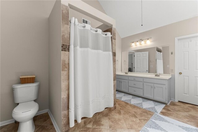 1172 Malvern Hunt Ct, Lawrenceville, GA 30043 - bathroom featuring a shower with curtain, double vanity, toilet, lofted ceiling, and baseboards