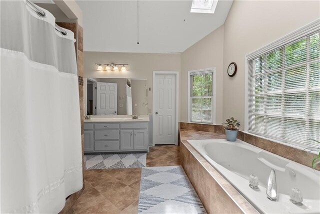 1172 Malvern Hunt Ct, Lawrenceville, GA 30043 - full bath with lofted ceiling, a skylight, a bath, vanity, and tile patterned floors