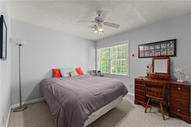 1172 Malvern Hunt Ct, Lawrenceville, GA 30043 - bedroom with baseboards, light carpet, a textured ceiling, and ceiling fan