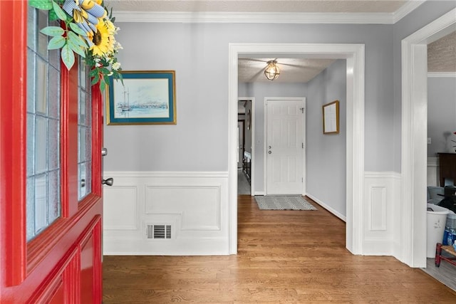 1172 Malvern Hunt Ct, Lawrenceville, GA 30043 - foyer with wood finished floors, a wainscoted wall, and crown molding
