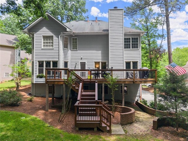 1172 Malvern Hunt Ct, Lawrenceville, GA 30043 - back of house featuring stairs, a wooden deck, a chimney, and a patio
