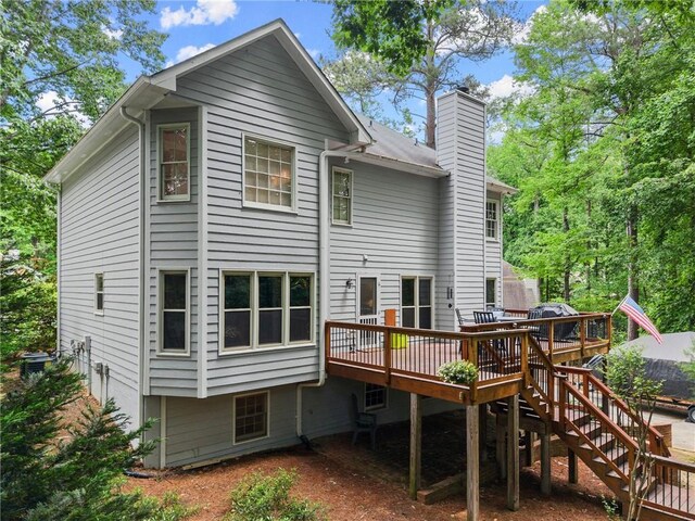 1172 Malvern Hunt Ct, Lawrenceville, GA 30043 - rear view of house with a wooden deck and a chimney