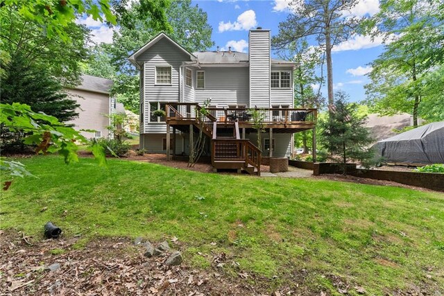 1172 Malvern Hunt Ct, Lawrenceville, GA 30043 - rear view of house featuring a deck, stairs, a chimney, and a lawn