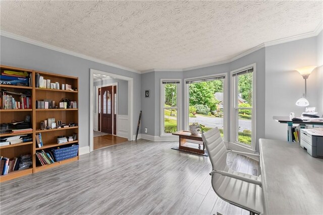1172 Malvern Hunt Ct, Lawrenceville, GA 30043 - sitting room with wood finished floors, a textured ceiling, ornamental molding, and baseboards