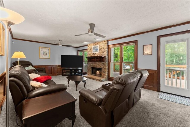1172 Malvern Hunt Ct, Lawrenceville, GA 30043 - carpeted living area with a wainscoted wall, a textured ceiling, ceiling fan, ornamental molding, and a fireplace