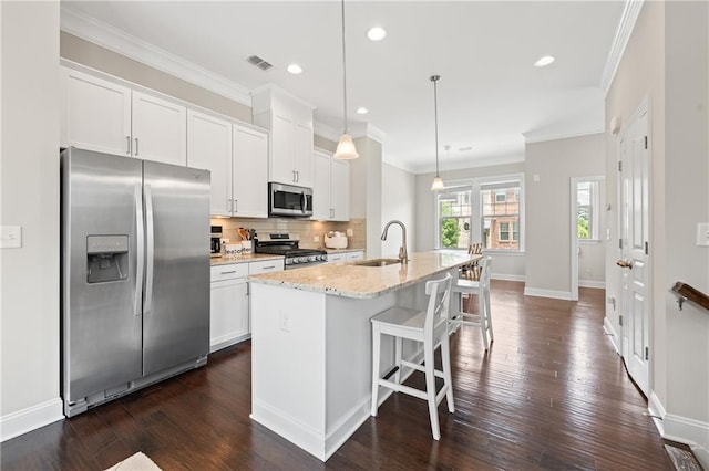 4458 Dunblane Ave, Sugar Hill, GA 30518 - kitchen featuring stainless steel appliances, a center island with sink, white cabinets, a breakfast bar, and dark wood-style flooring