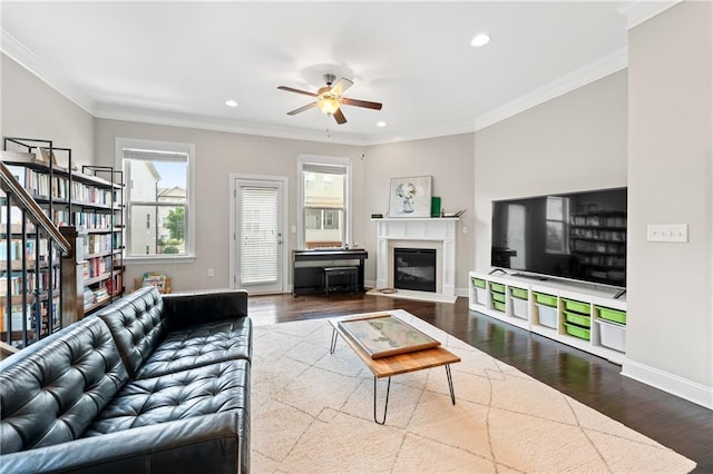 4458 Dunblane Ave, Sugar Hill, GA 30518 - living area with wood finished floors, a ceiling fan, healthy amount of natural light, recessed lighting, and ornamental molding
