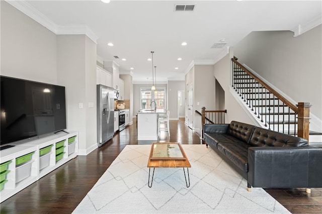 4458 Dunblane Ave, Sugar Hill, GA 30518 - living area featuring ornamental molding, dark wood-style flooring, recessed lighting, and stairs