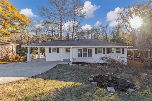 ranch-style house featuring a carport and a front yard