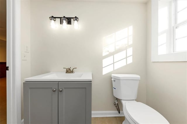 bathroom featuring tile patterned floors, vanity, and toilet