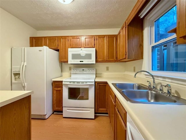 3533 Mulberry Way, Duluth, GA 30096 - kitchen featuring white appliances, light wood-style flooring, brown cabinetry, light countertops, and a textured ceiling