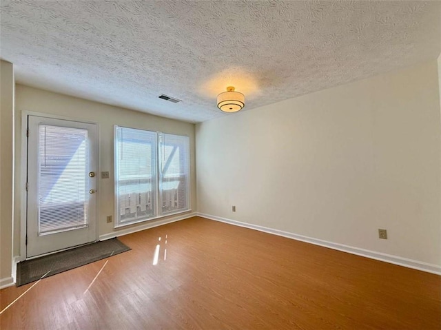 3533 Mulberry Way, Duluth, GA 30096 - unfurnished room featuring wood finished floors and a textured ceiling