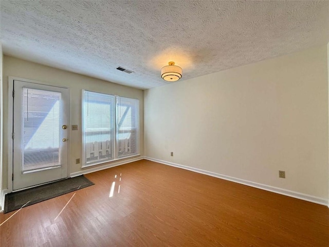 3533 Mulberry Way, Duluth, GA 30096 - empty room featuring wood finished floors and a textured ceiling