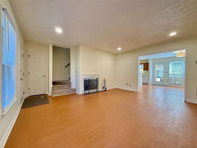 3533 Mulberry Way, Duluth, GA 30096 - unfurnished living room featuring wood finished floors, recessed lighting, stairway, and a textured ceiling