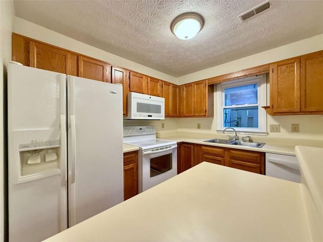 3533 Mulberry Way, Duluth, GA 30096 - kitchen with white appliances, a textured ceiling, light countertops, and brown cabinetry