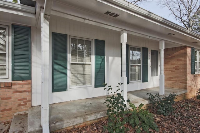 view of side of property with covered porch