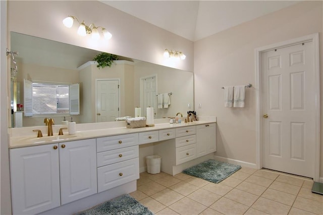 6765 Crofton Dr, Alpharetta, GA 30005 - bathroom with tile patterned floors, double vanity, vaulted ceiling, and baseboards